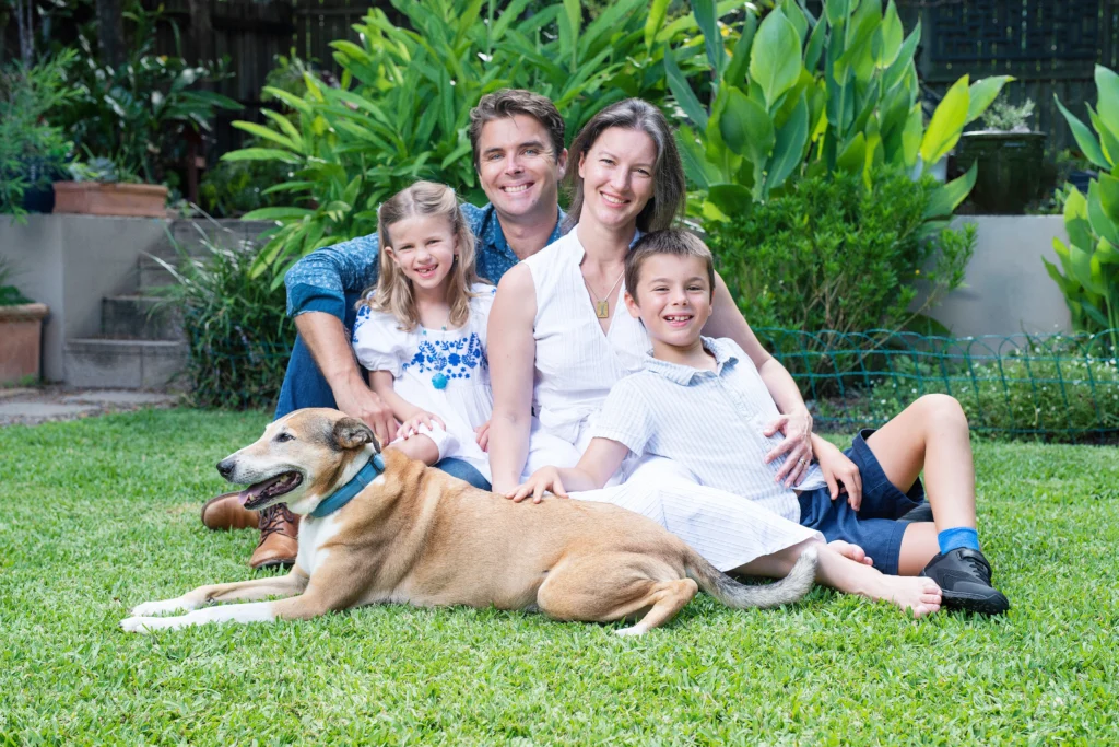 Travis, Emily and their family sitting outside