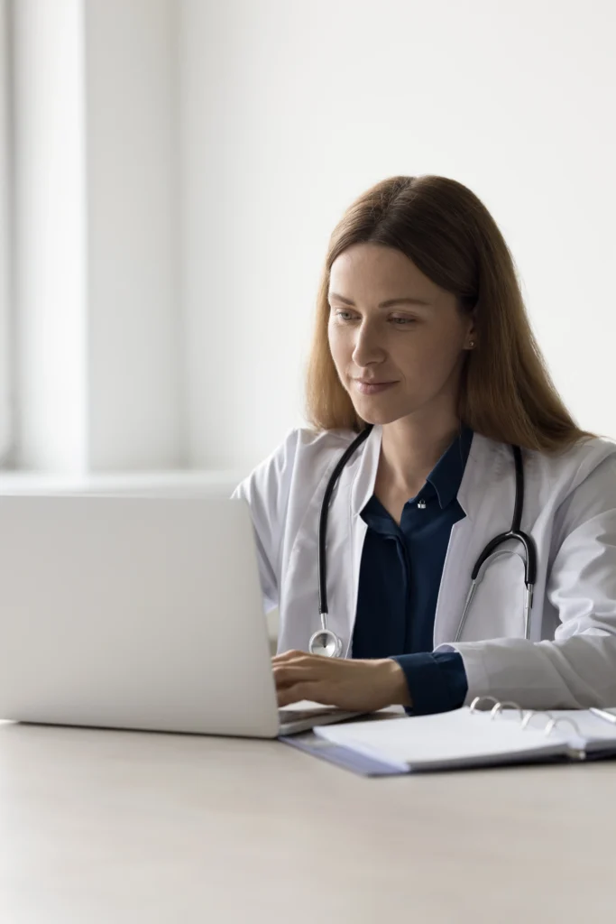 Nurse sitting and working on a laptop